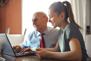 Blog 5 a woman and man looking at a laptop